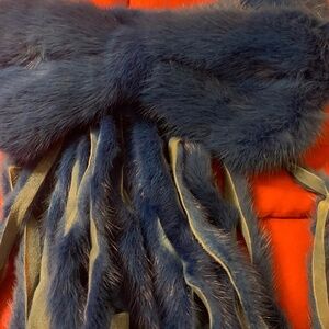 A Genuine Mink Bow attached to the front of the collar.